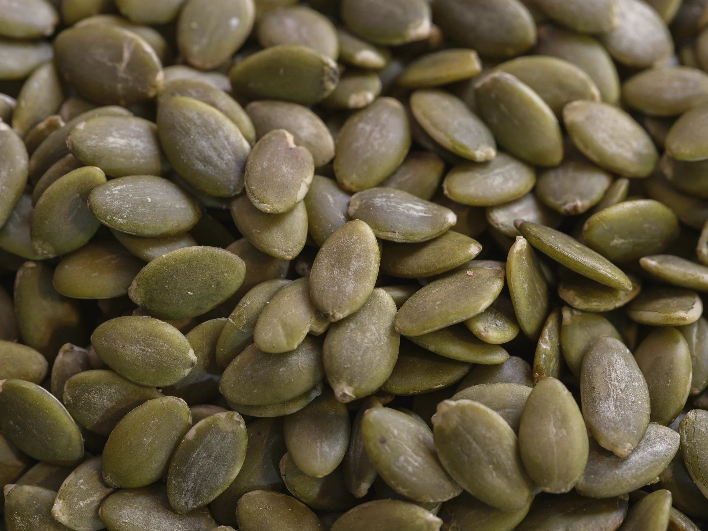 A close view of raw green pumpkin seeds